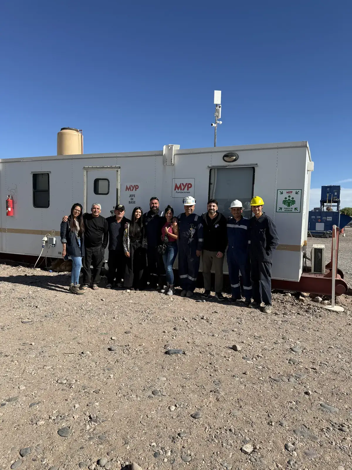 An organization's team in front of their facilities